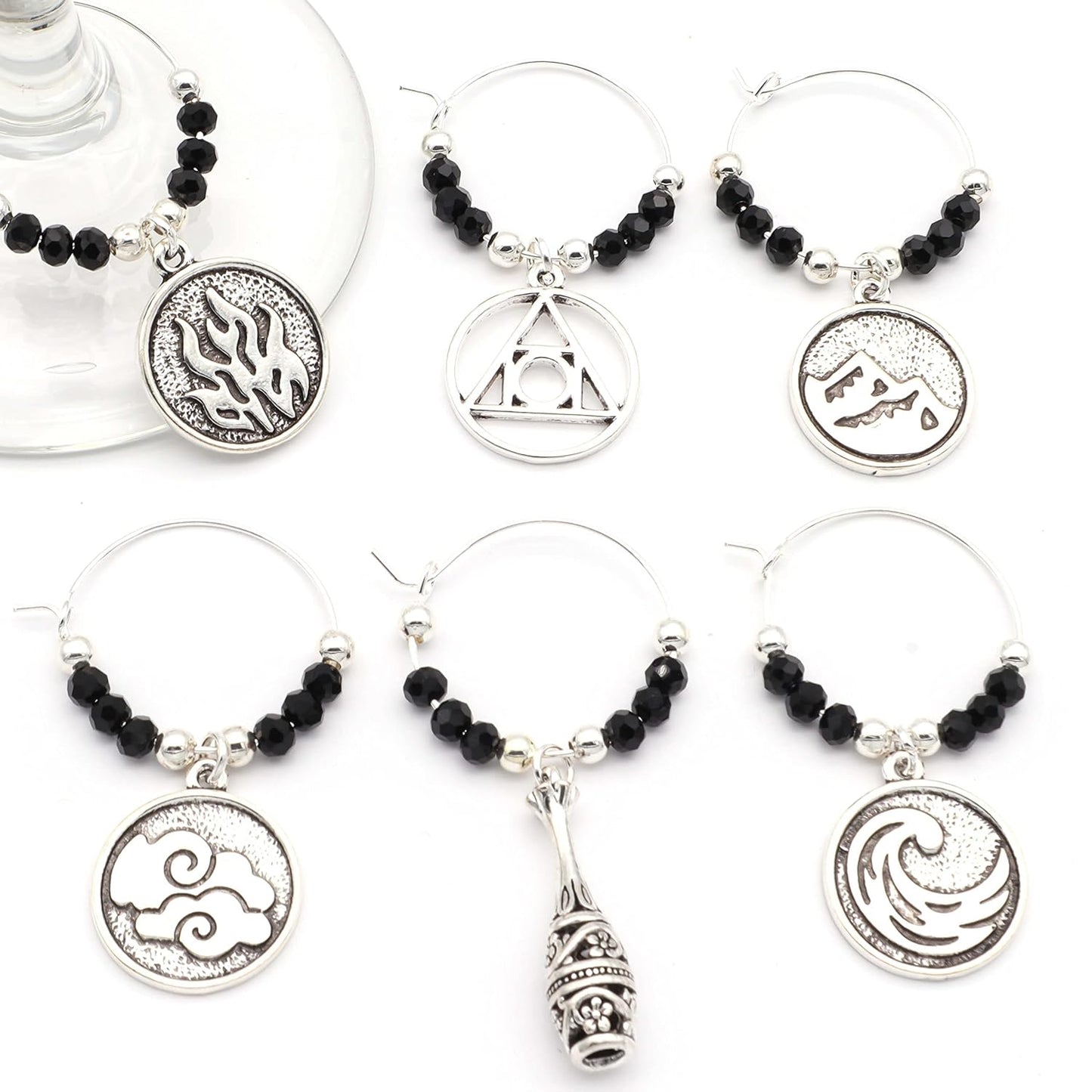 Four Elements Alchemy Wine Charms on a white surface