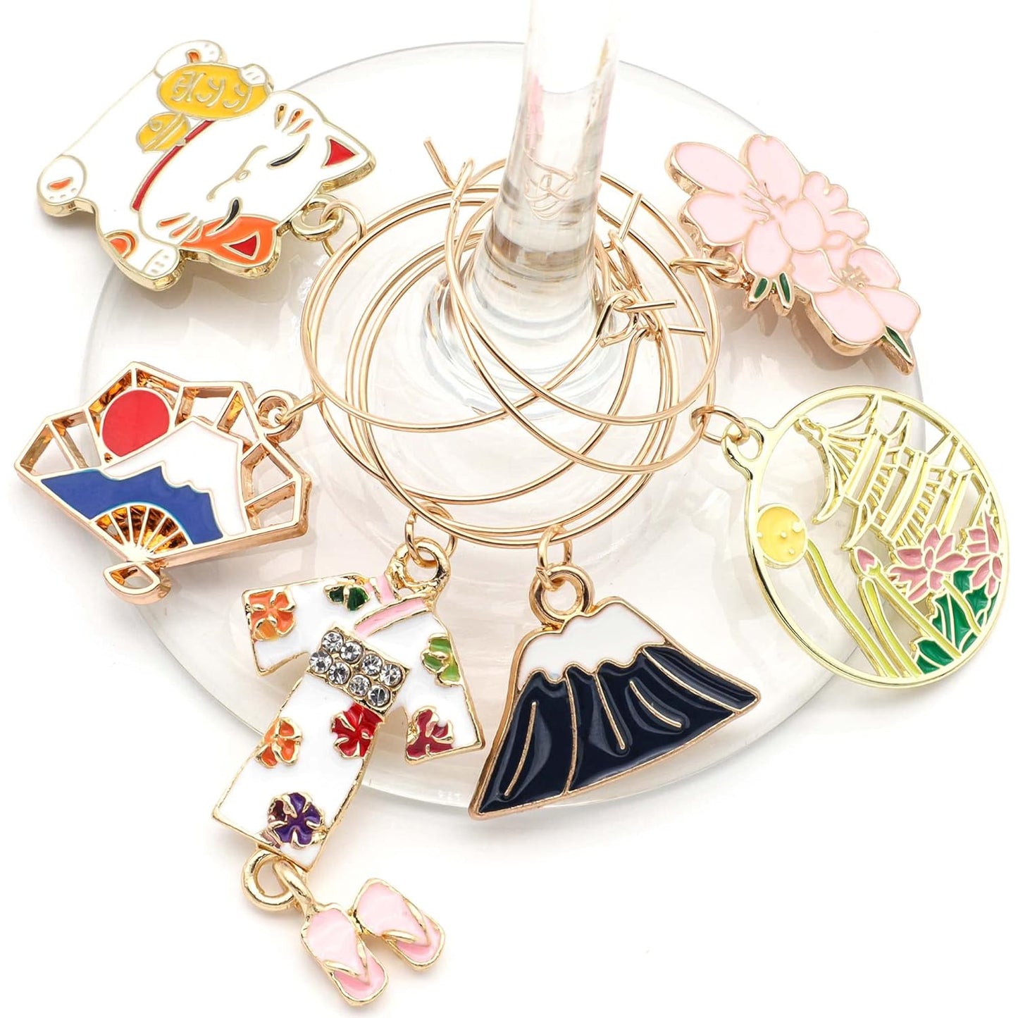 A set of Japanese Wine Charms hooked on the glass.