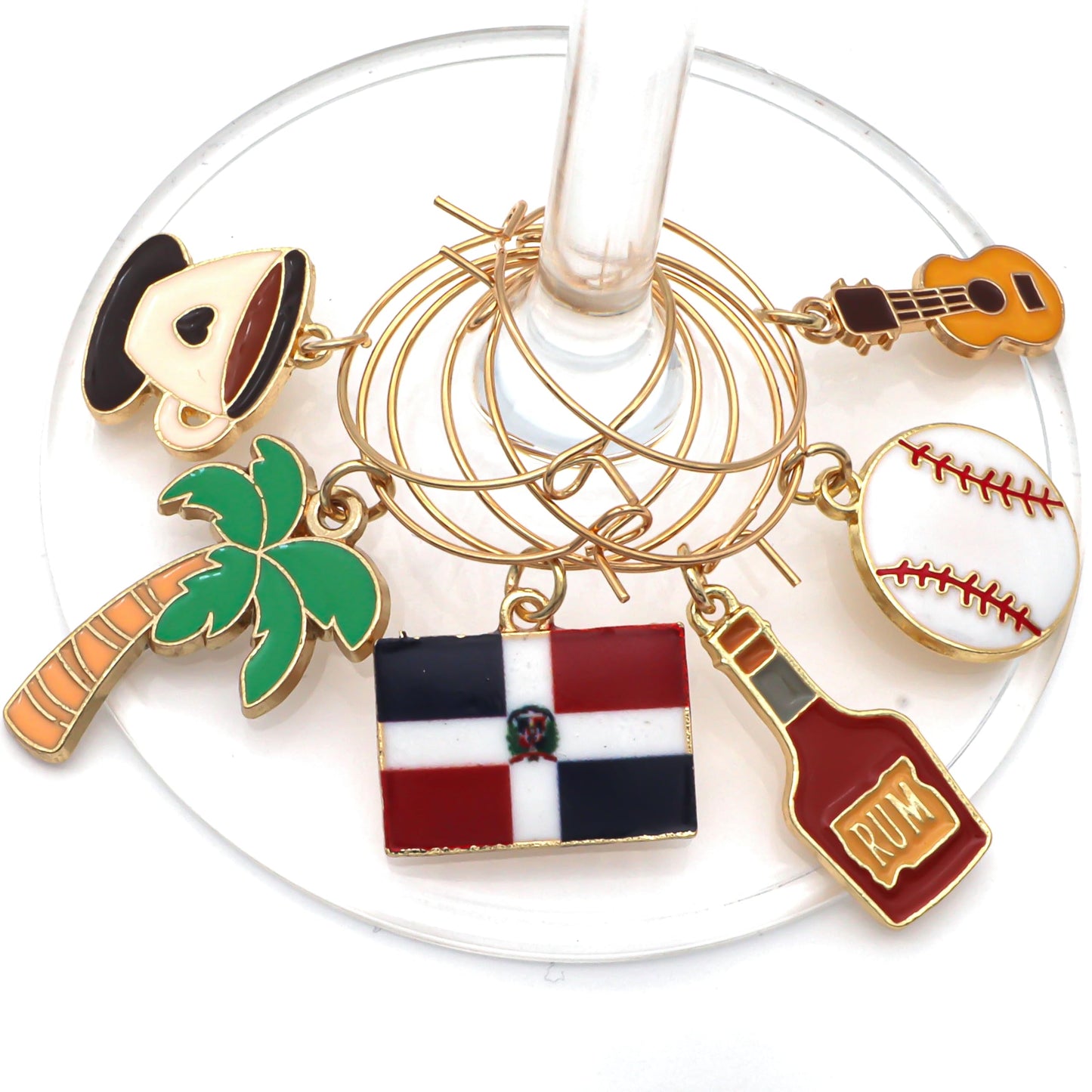 A set of Dominican Republic Wine Charms featuring the flag, palm trees, coffee, baseball, rum, and guitar hooked on the glass.