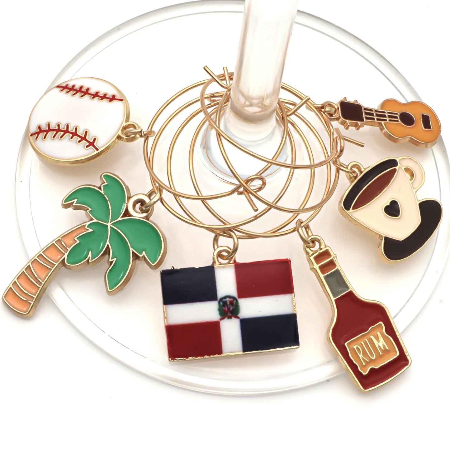 A set of Dominican Republic Wine Charms featuring the flag, palm trees, coffee, baseball, rum, and guitar hooked on the glass.