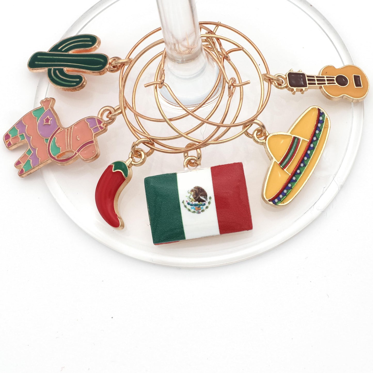 Pinata, Mexican Flag, Chili Pepper, Cactus, Guitar, and Sombrero hooked on the wine glass.