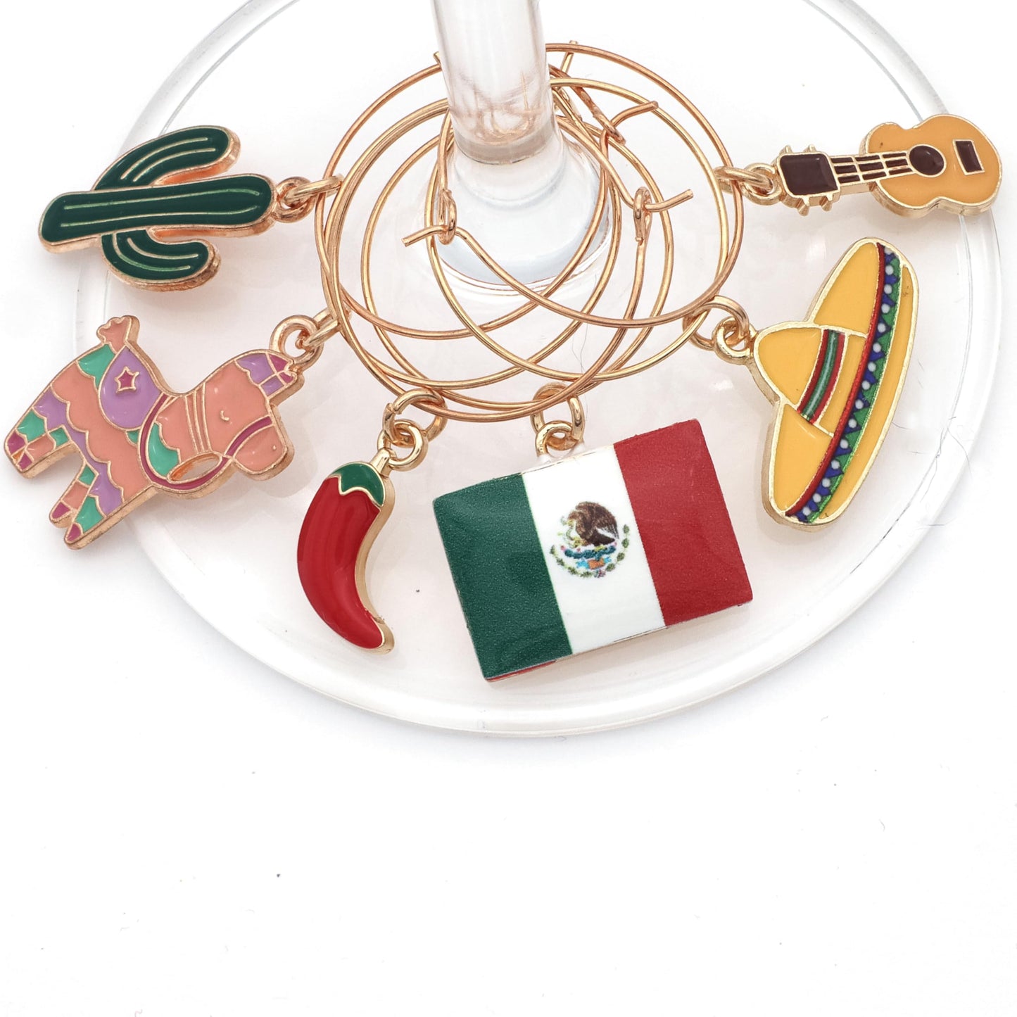 Piñata, Mexican Flag, Chili Pepper, Cactus, Guitar, and Sombrero hooked on the wine glass.