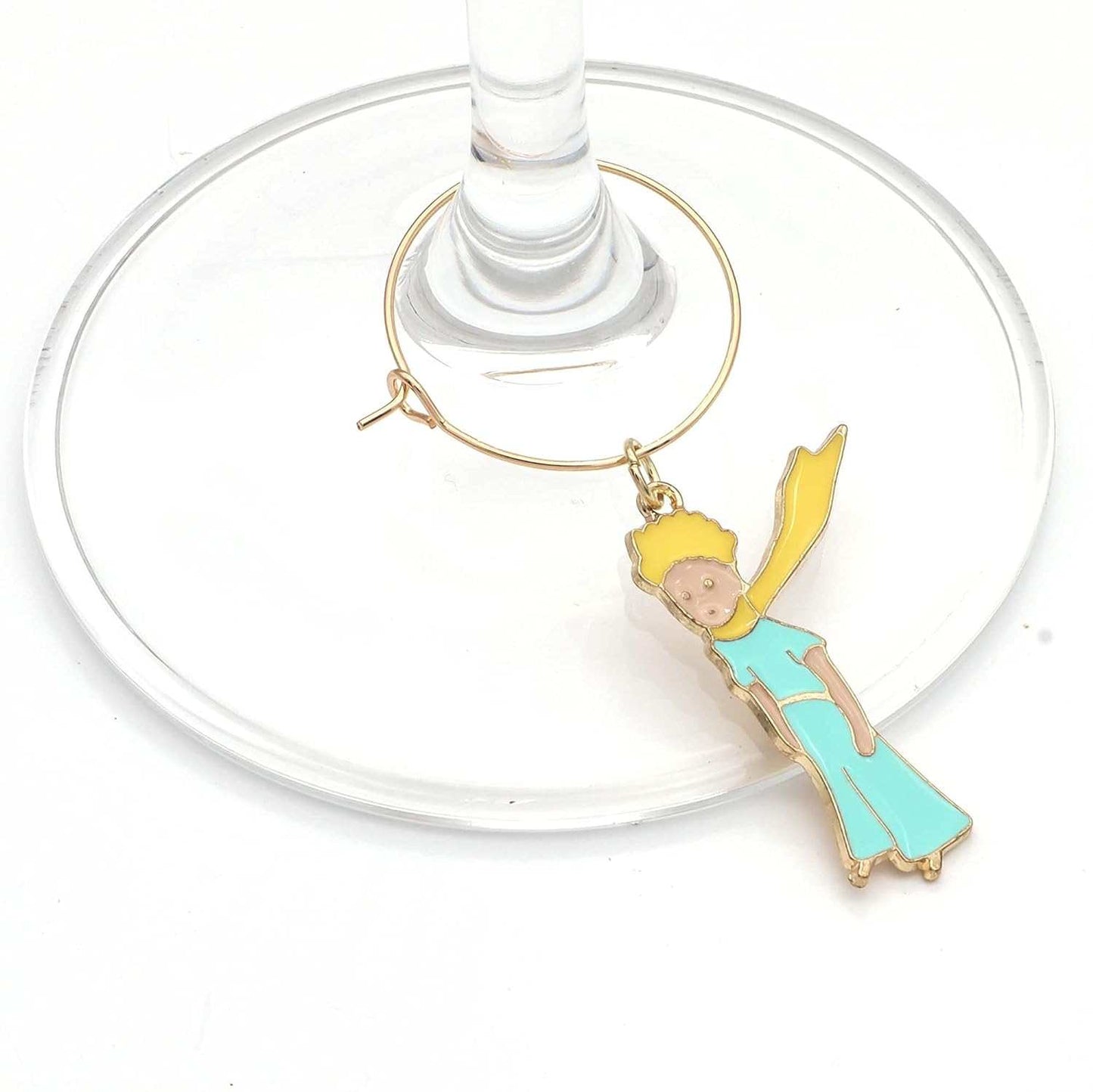 The Little Prince Wine Charms hooked on the glass.