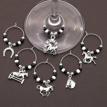 Horse Wine Glass Charms on a brown surface.