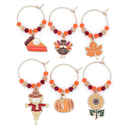 A set of Thanksgiving Wine Charms on the white surface.