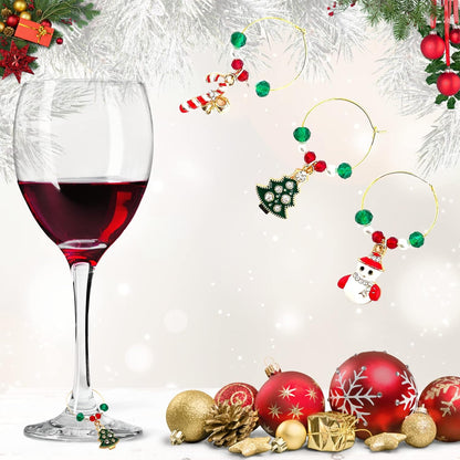 A set of Christmas Wine Charms featuring including Santa, Candy Cane, Snowman, Christmas Bells, Stocking, and Christmas Tree on a white surface, with red wine and Christams decoration.