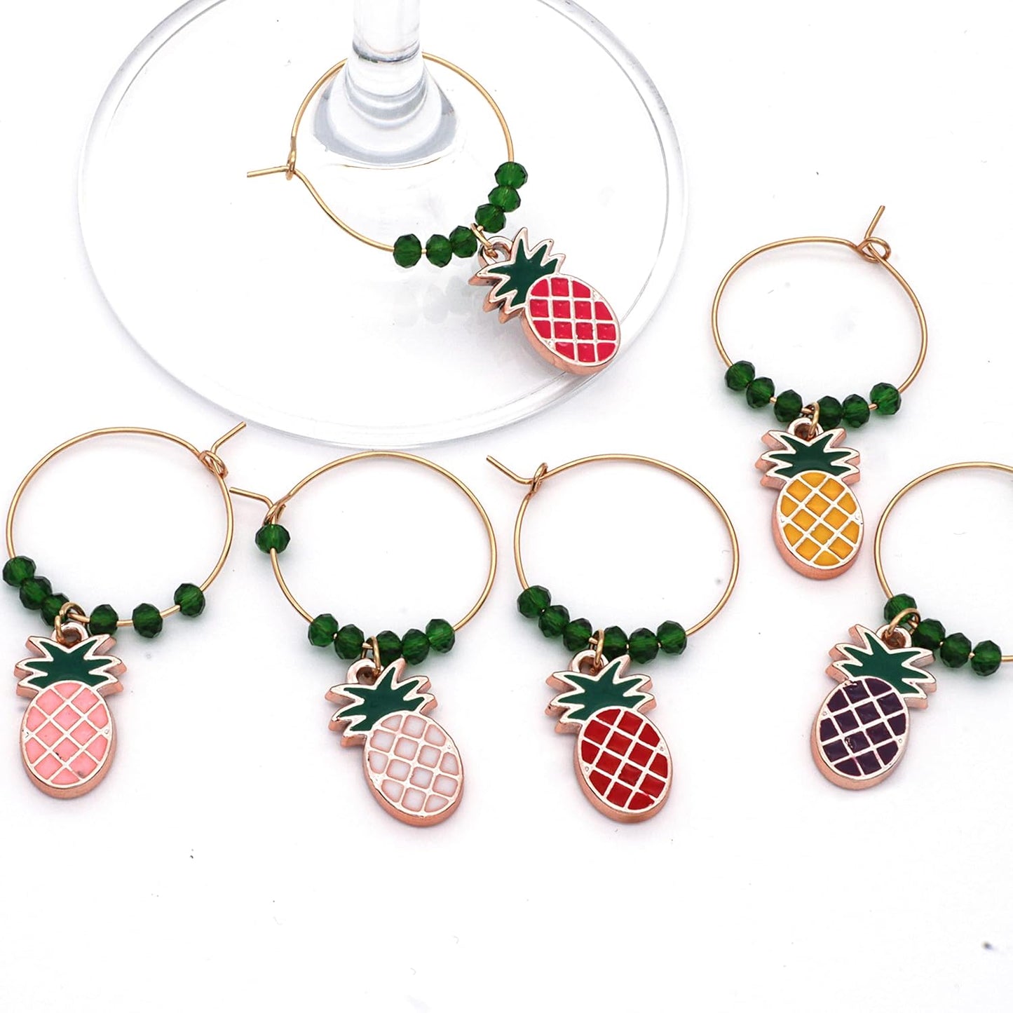 Pineapple Wine Charms on a white surface.