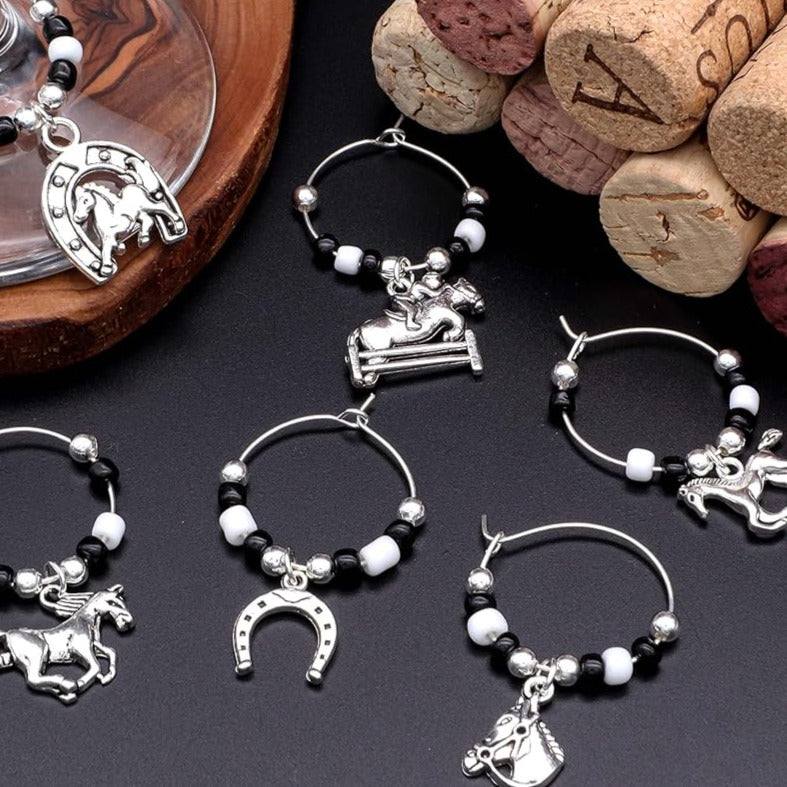 Horse Wine Glass Charms on a black Surface.