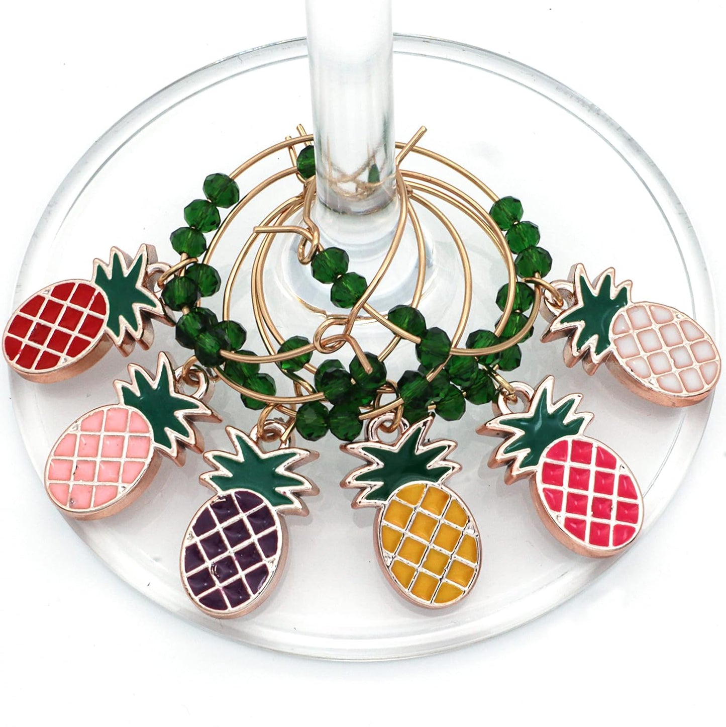 Pineapple Wine Charms hooked on the glass.