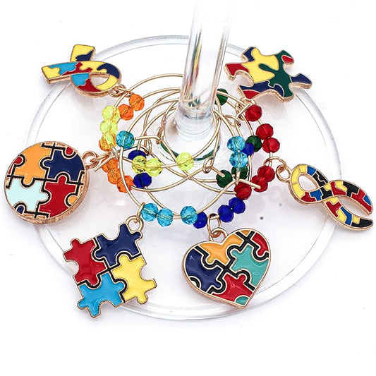 Autism Awareness Glass Charms feature puzzle piece designs that hook onto the glass.