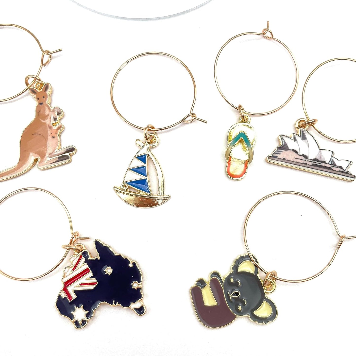 Australia Wine Charms Sydney Opera House, Kangaroo and Koala, Boat, and Flag on the white surface.