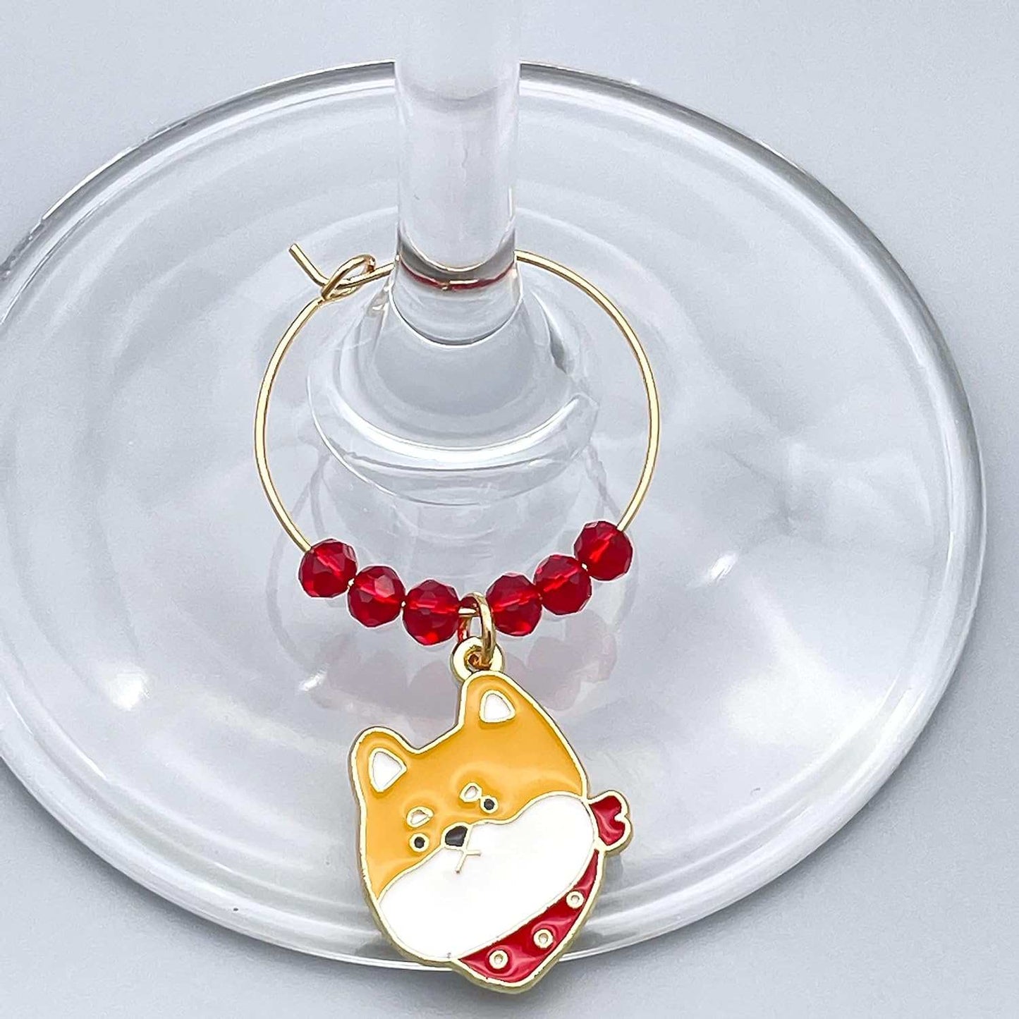 Yellow- Colored Pitbull Dog Wine Charms hooked on the wine glass.