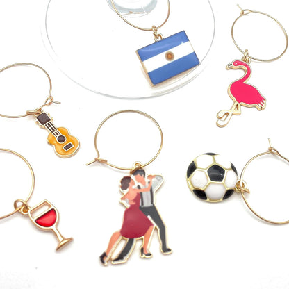 Argentina Wine Charms guitar, flamingo, flag, tango dancers, soccer ball, and wine on the white surface.