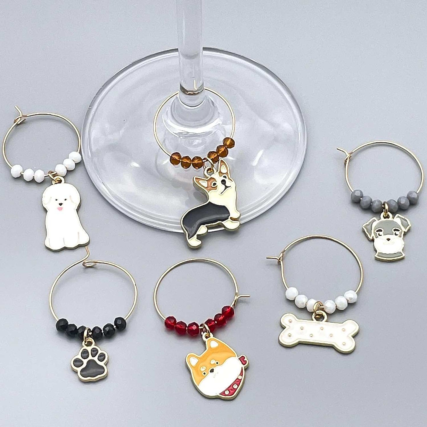 Dog Wine Charms on a grey surface.