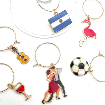 Argentina Wine Charms guitar, flamingo, flag, tango dancers, soccer ball, and wine on the white surface.