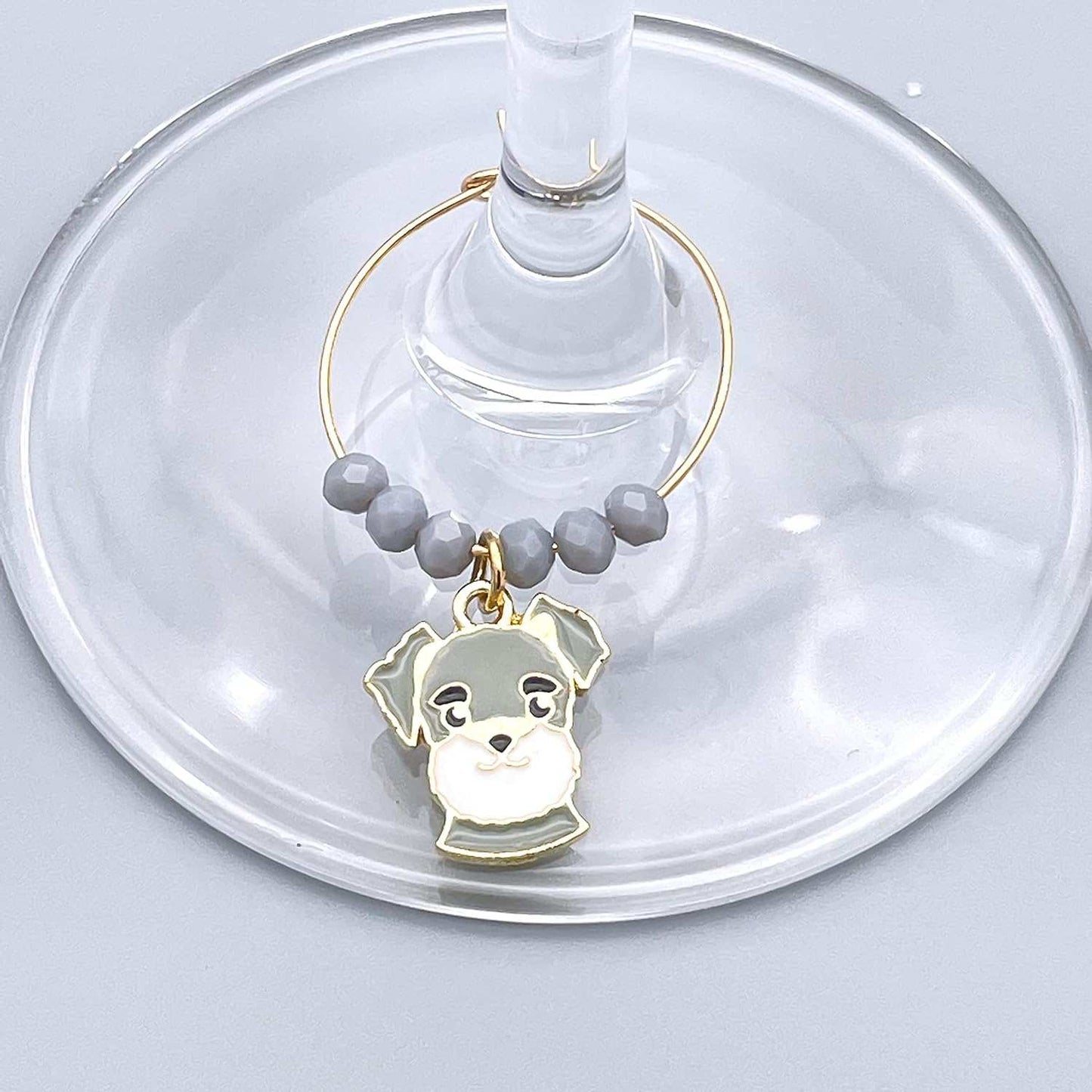 Grey colored Dog Wine Charms hooked on the wine glass.