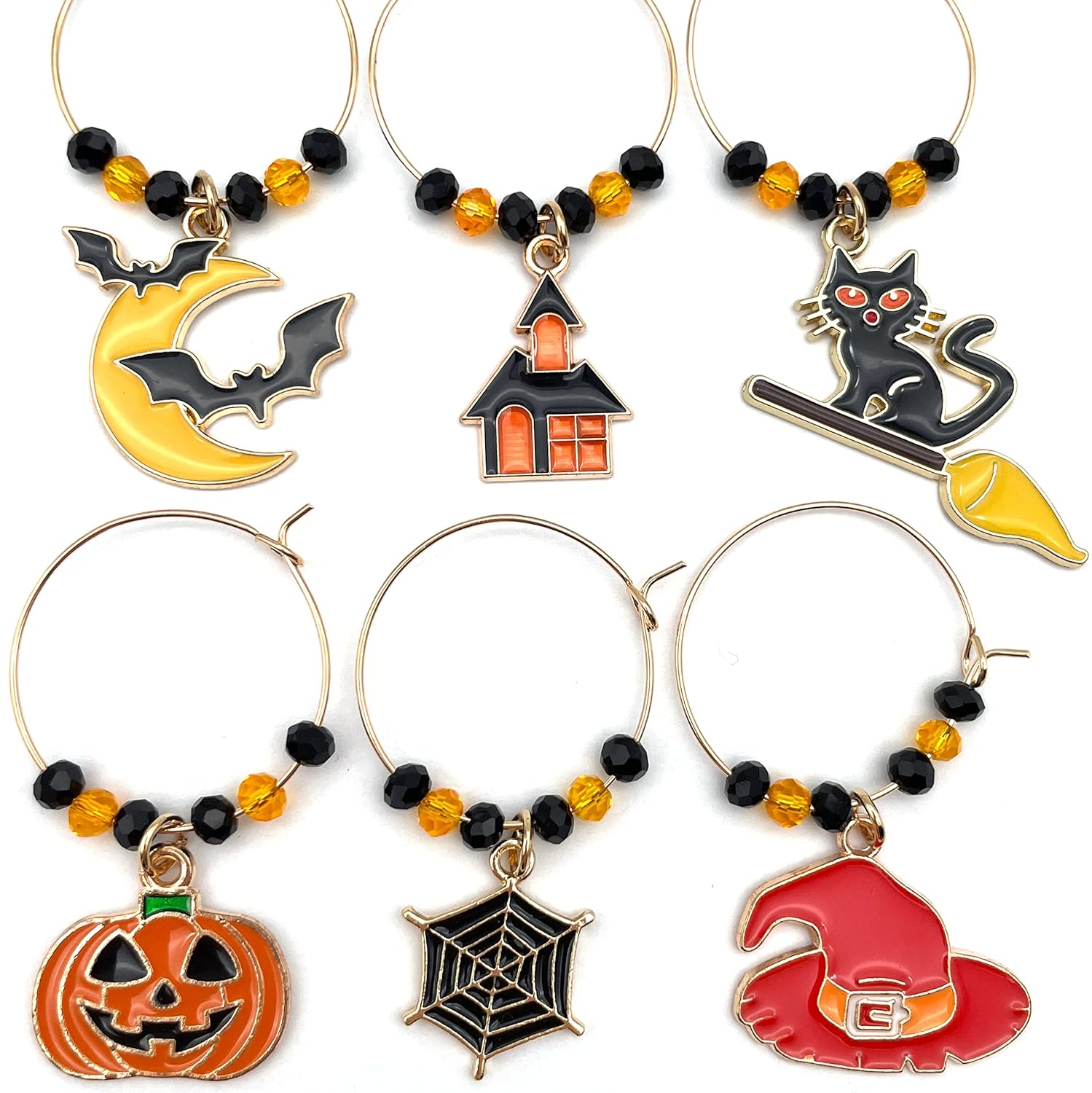 Halloween Wine Charms set of witch hat, bat, spider web, jack-o'-lanterns, and black cat on a white surface.