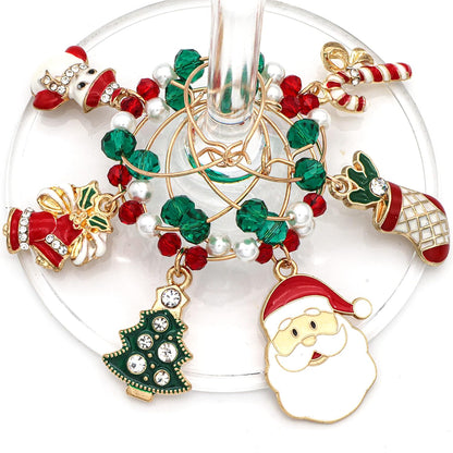 A set of Christmas Wine Charms featuring including Santa, Candy Cane, Snowman, Christmas Bells, Stocking, and Christmas Tree hooked on the wine glass.