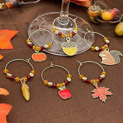 Thanksgiving Themed Wine Charms on a brown surface.