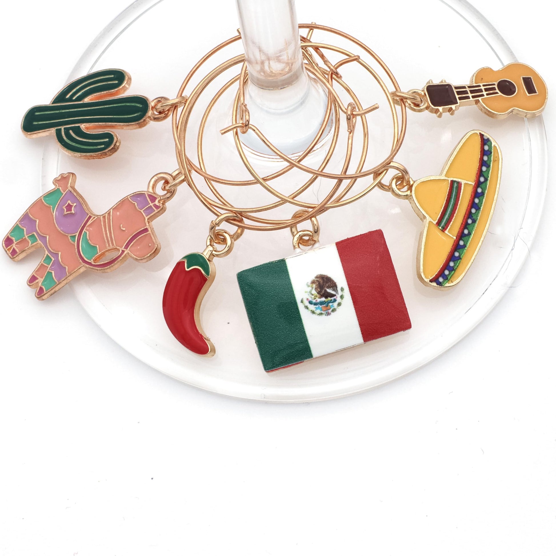 Piñata, Mexican Flag, Chili Pepper, Cactus, Guitar, and Sombrero hooked on the wine glass.