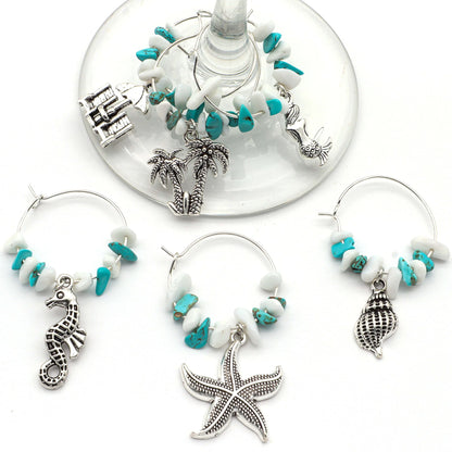 Ocean Wine Charms featuring palms, shells, seahorses, sea stars, and mermaids hooked on the wine glass.